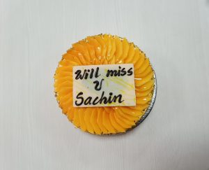 A farewell cake adorned in yellow hues featuring a heartfelt "will miss you" message.